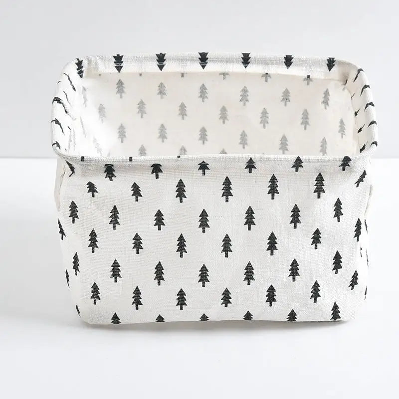 A white storage basket with a black pine tree pattern, made of waterproof cotton linen.