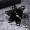 A black leather flower shaped like a Phalaenopsis orchid is attached to a silver keyring.