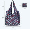 A dark blue and white fish print tote bag with black straps, shown against a white background.