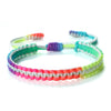 Handmade braided rope bracelet with colorful beads and green, purple, and pink accents.