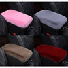 A set of plush car armrest cushions in pink, gray, brown, and red colors shown in a vehicle interior.