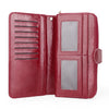 A maroon wax leather long wallet with a wrist strap shown open, displaying two clear pockets.