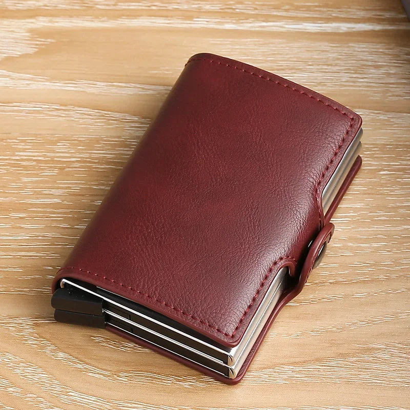 A dark burgundy leather double layer ID card holder wallet resting on a light wooden surface.
