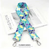 A blue and yellow patterned nylon shoulder strap for bags and purses displayed next to its packaging.