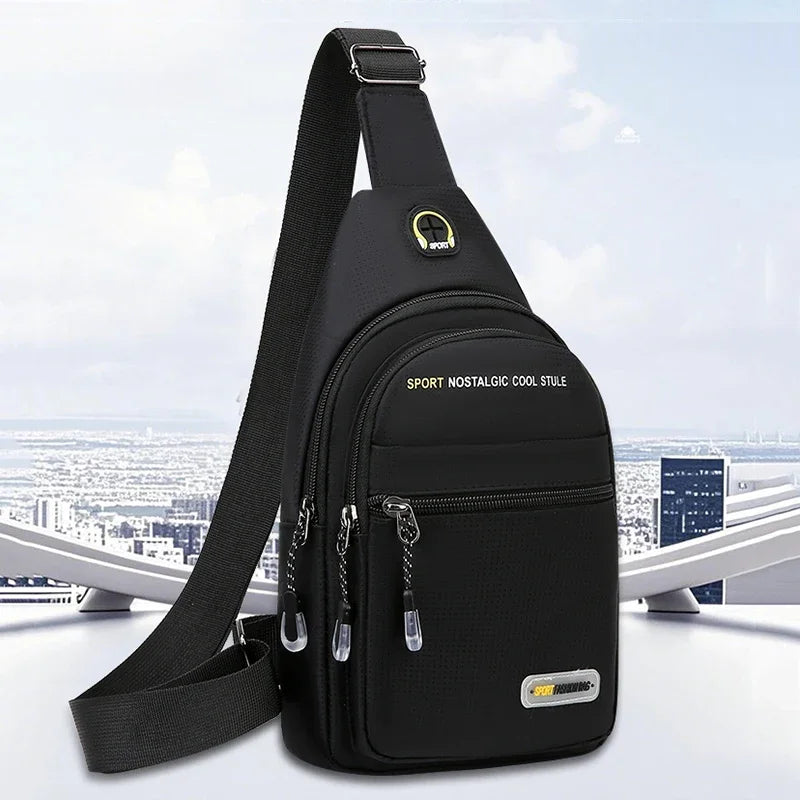 Black men's casual multi-pocket shoulder bag with a black strap shown against a bright sky background.