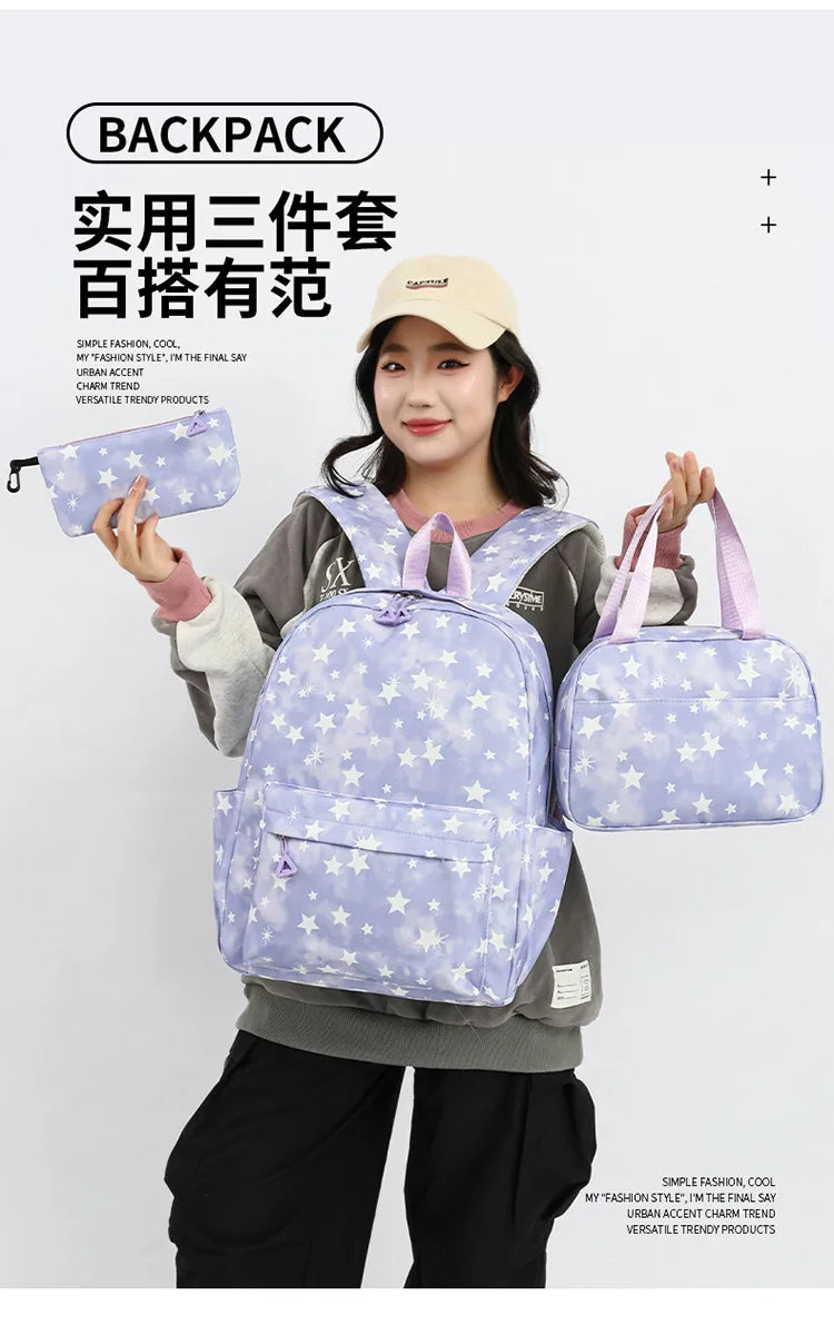A woman is holding a purple star-patterned nylon backpack set, including a backpack and a pouch, against a light gray backgro