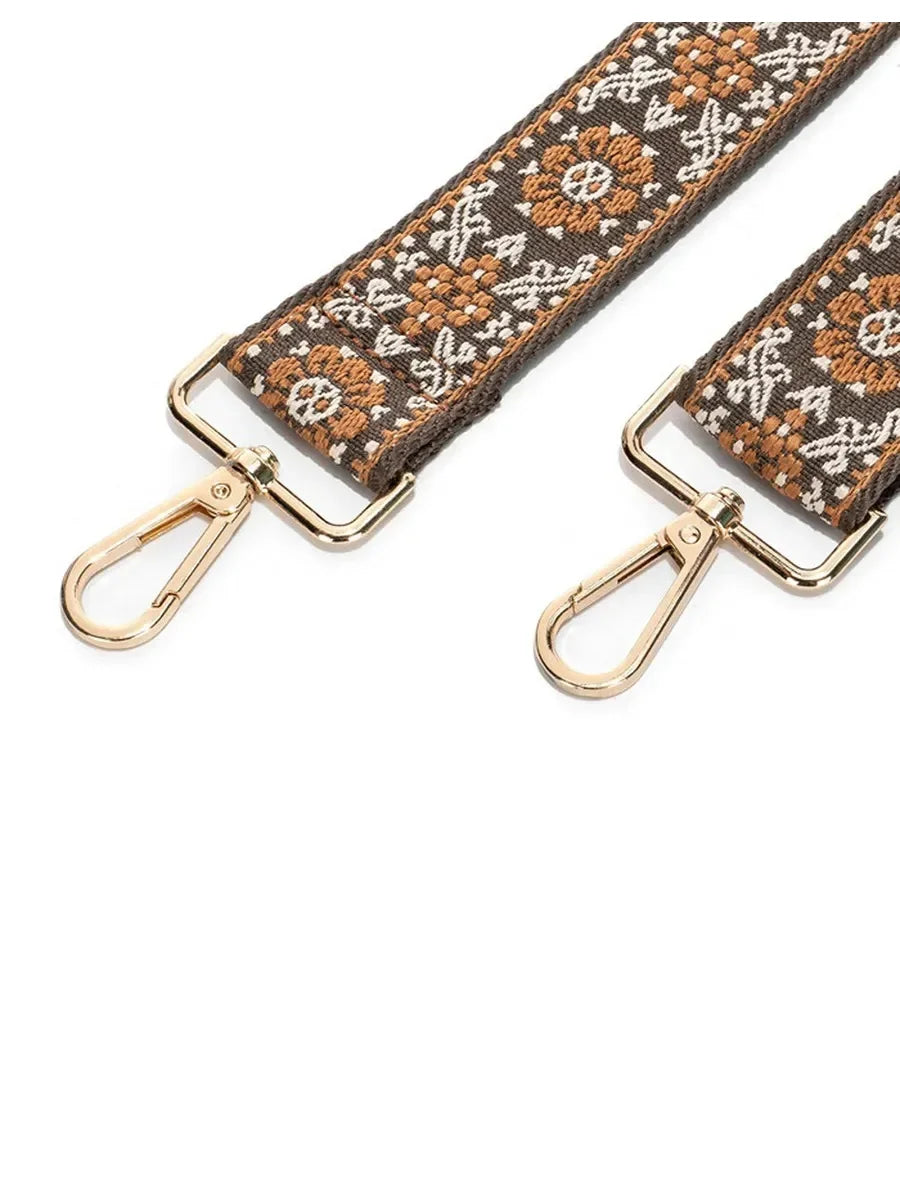 A brown and beige patterned textile replacement bag strap with gold-toned hardware.