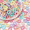 A pile of colorful acrylic link chain connectors in various pastel shades for DIY jewelry making