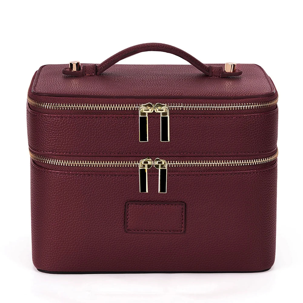 A maroon double-layer makeup storage case with gold zipper pulls and a leather finish.