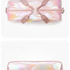 A pink iridescent nylon travel bag with a strap closure.