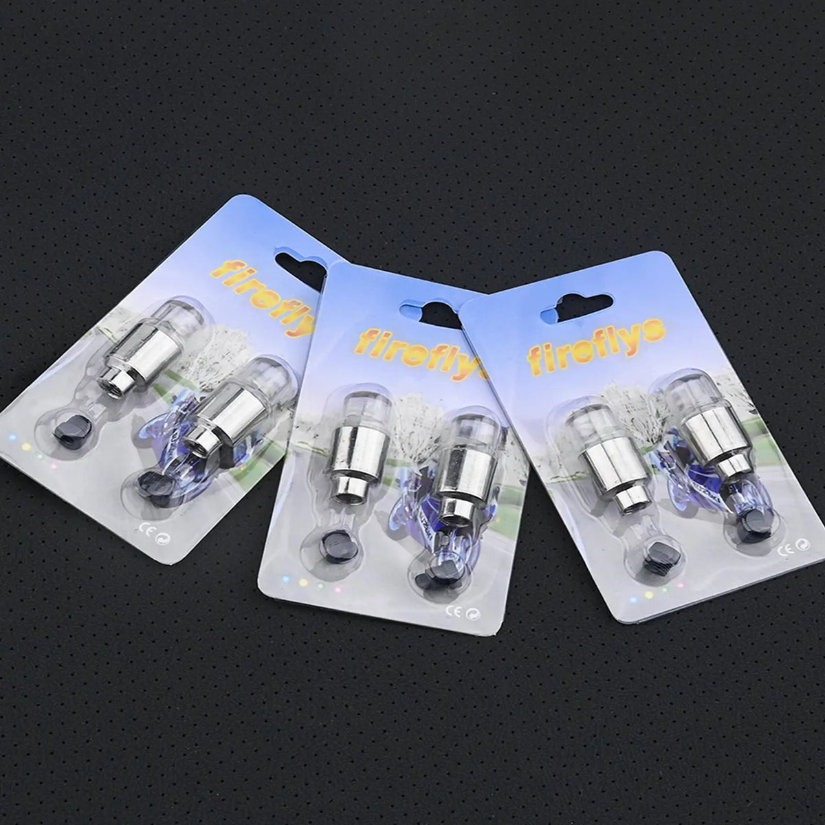 A pack of two LED tire valve stem lights packaged in clear plastic pouches