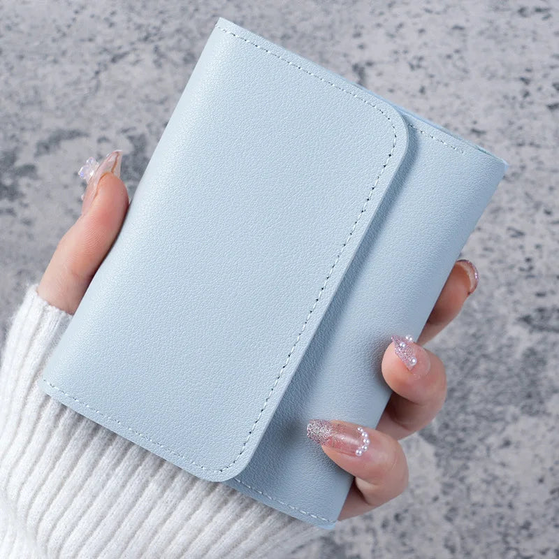 A hand holds a light blue slim multi-functional card wallet for students.