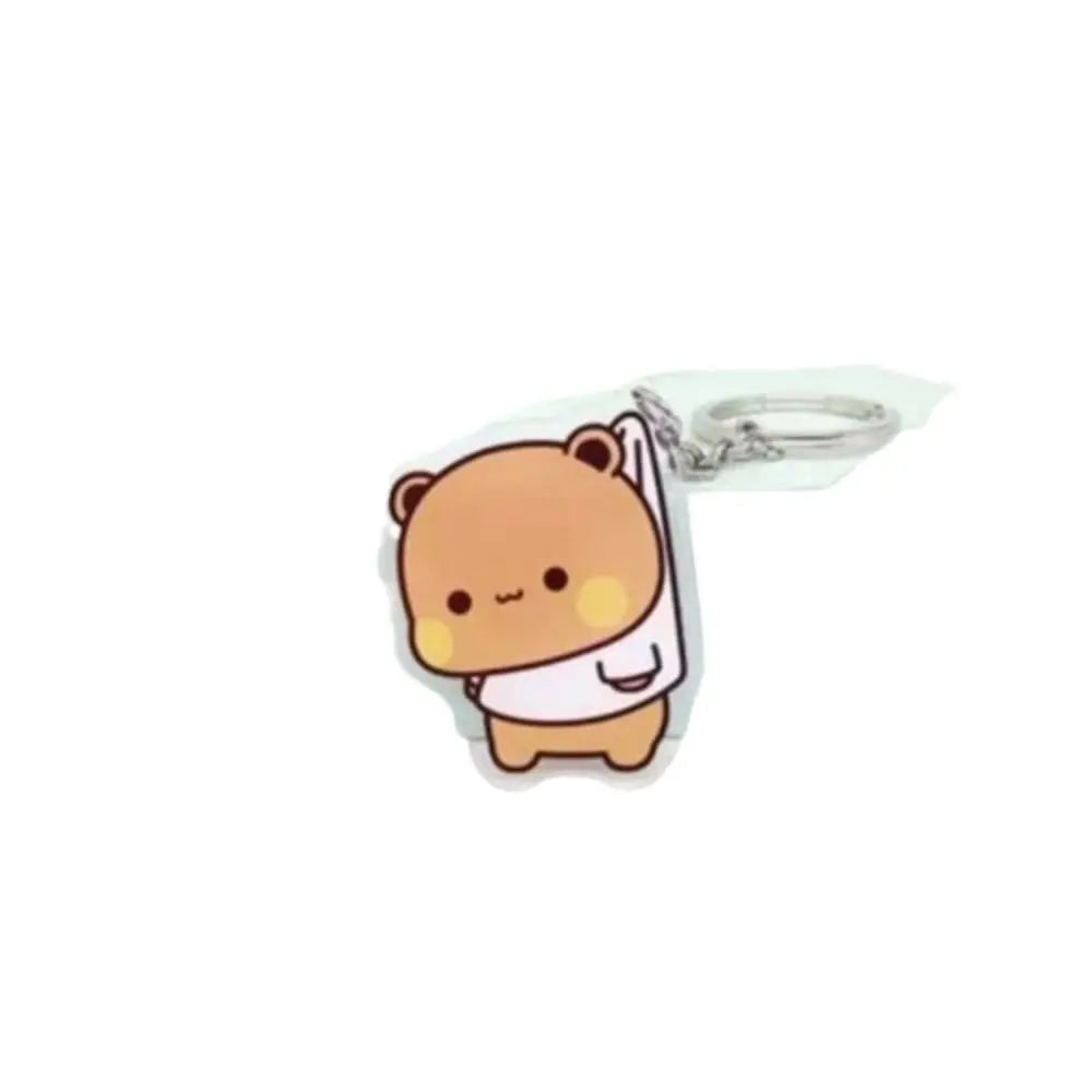 A cute cartoon character keychain charm made of resin in a light brown color.