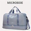 A light blue microside duffle bag with gray straps and a silver zipper, shown from the front.