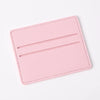 Porta tarjetas de cuero sintético rosa con dos ranuras horizontales.