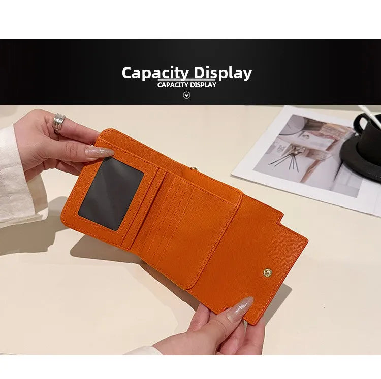 An orange multi-slot card holder is being held by a hand, displayed next to a card.
