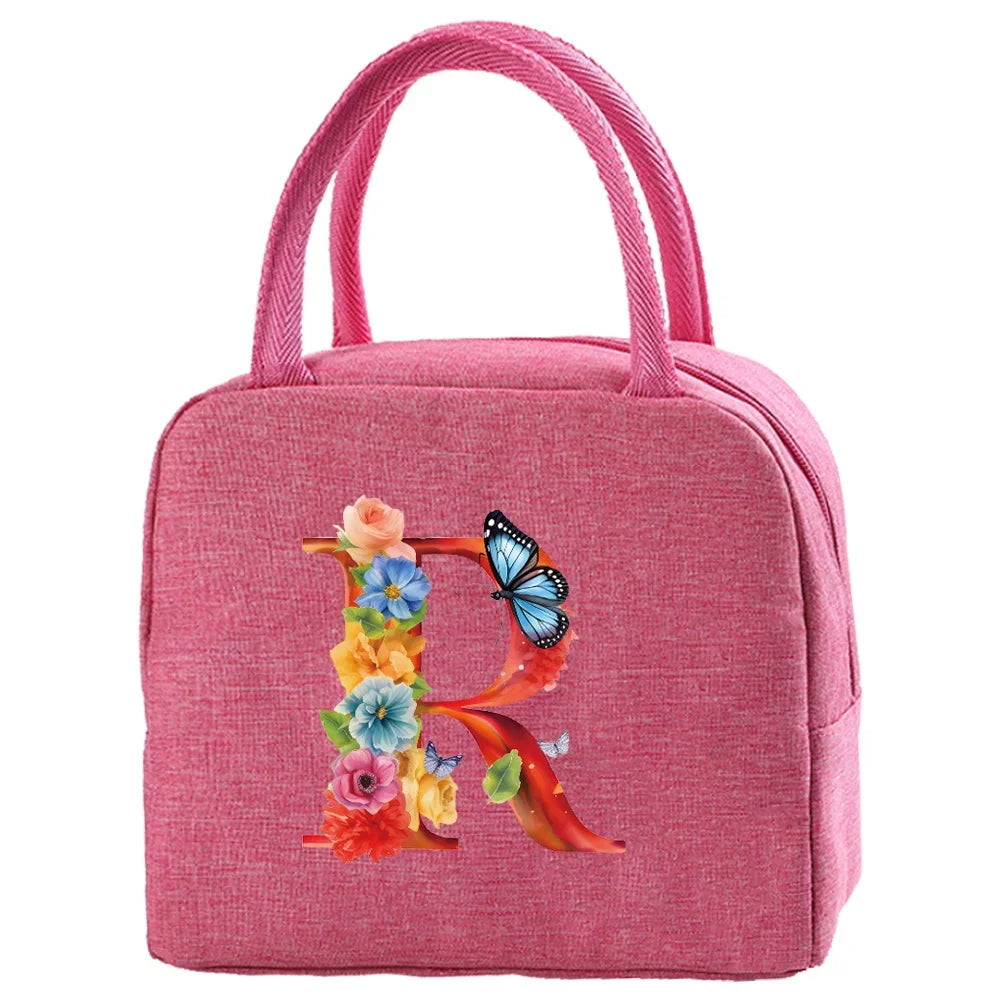 A pink insulated canvas lunch bag featuring a floral and butterfly design.