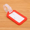 An orange luggage tag with a white label for name, address, and city/state, attached to a clear plastic strap.