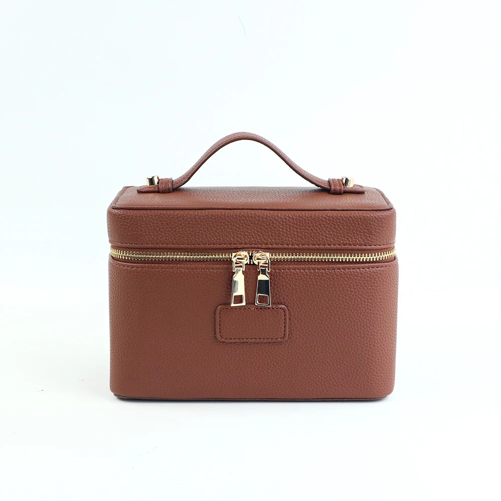 A brown PU leather makeup bag with a zipper closure and carrying loop.