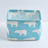 A light blue storage basket lined with white fabric featuring silhouettes of pandas.