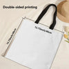 A white reusable tote bag with black handles, showing double-sided printing on the fabric.