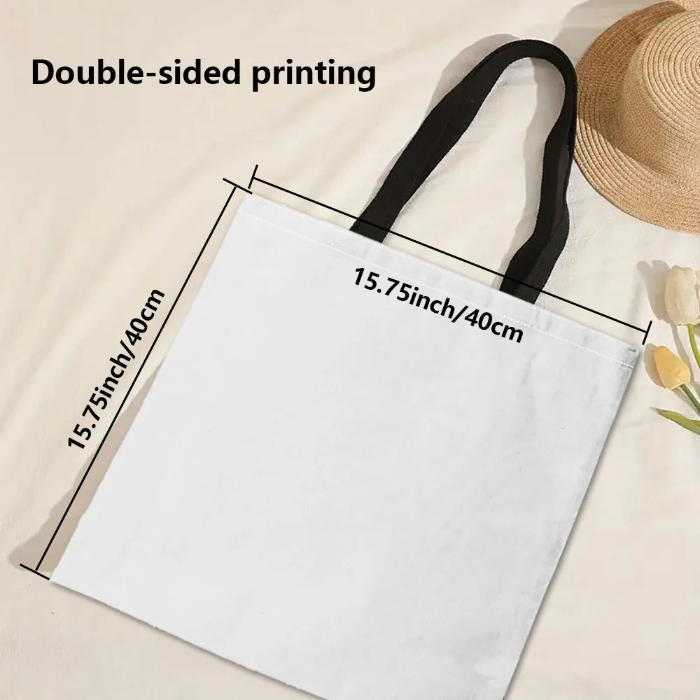 A white reusable tote bag with black handles, showing double-sided printing on the fabric.