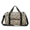 A black and beige leopard print travel duffel bag with a shoulder strap.