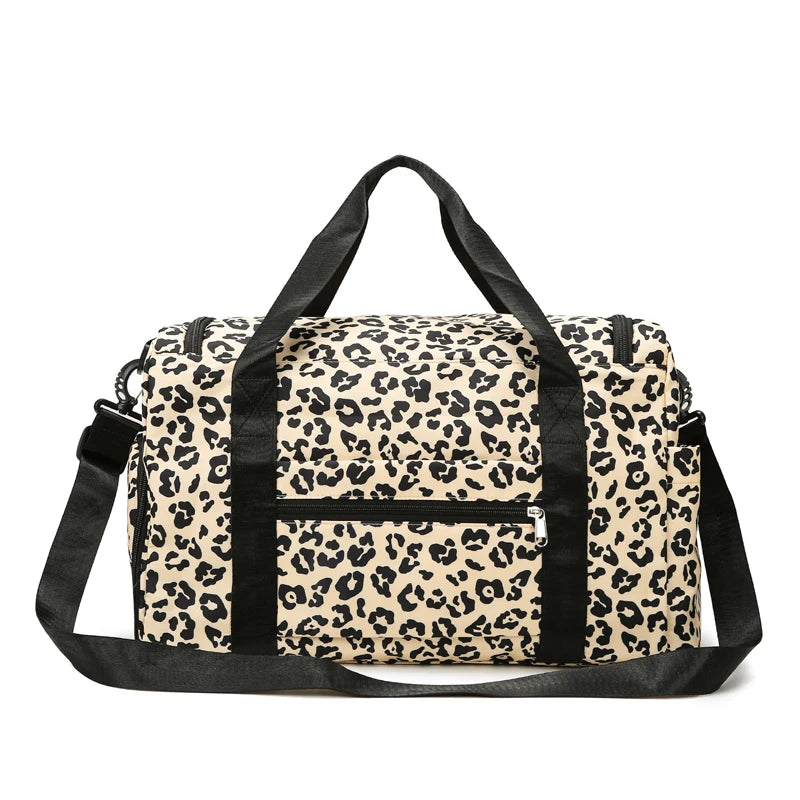A black and beige leopard print travel duffel bag with a shoulder strap.