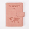 A pink leather passport wallet cover with the word PASSPORT and a world map design.