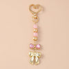 Gold pearl bow heart keychain with pink accents for bags and keys
