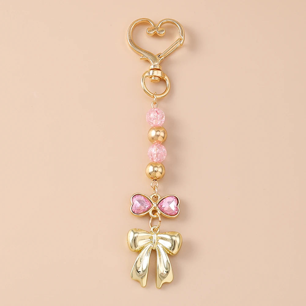 Gold pearl bow heart keychain with pink accents for bags and keys
