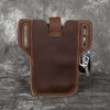 A brown genuine leather men's waist bag with stitching and a metal clasp is shown against a dark gray background.