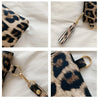 A leopard print PU leather wrist bag featuring gold hardware and a textured finish.