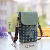 A teal denim mini messenger bag with gold hardware resting on a white surface.