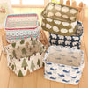 A collection of various patterned storage baskets made from cotton linen for desk organization.