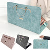 A collection of slim PU laptop protective cases in teal and gray colors shown next to a person's hand.
