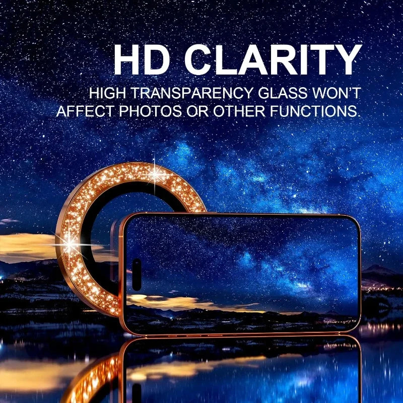 A close-up of a glitter diamond camera lens protector with a metal frame resting on a smartphone against a starry night backg