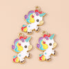 Two gold-toned unicorn horse charm pendants featuring rainbow colors and white enamel on a beige background.