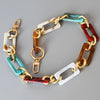 A multi-color acrylic chain strap featuring segments of gold, copper, green, and reddish-brown.