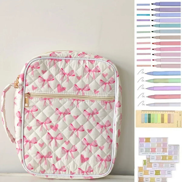 A white quilted floral bible cover with pink bows and a zippered pen holder is displayed against a light background.