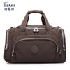 A dark brown nylon travel duffle bag with padded compartments and zipper details.
