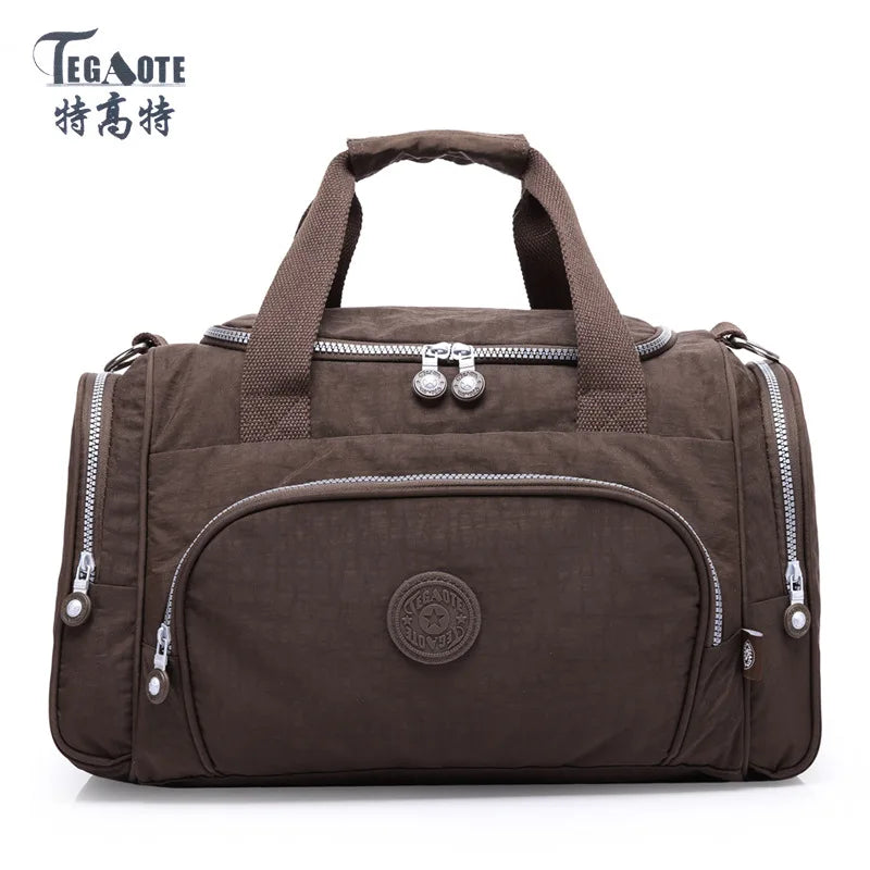 A dark brown nylon travel duffle bag with padded compartments and zipper details.