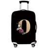Black luggage with a beige letter O design and floral embroidery