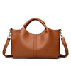 A brown luxury soft leather women's tote bag with a handle and shoulder strap.