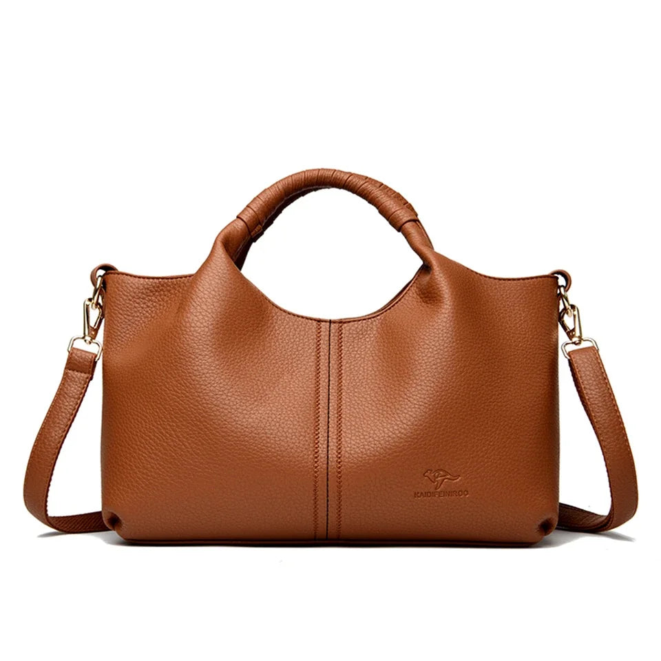A brown luxury soft leather women's tote bag with a handle and shoulder strap.