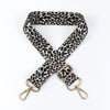 A black and tan leopard print adjustable crossbody strap for bags.
