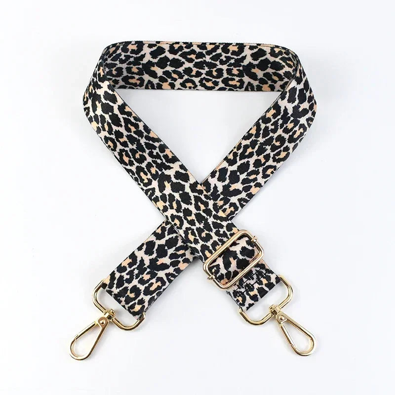 A black and tan leopard print adjustable crossbody strap for bags.