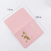 A pink elegant PU leather passport holder wallet with gold lettering and dimensions marked.