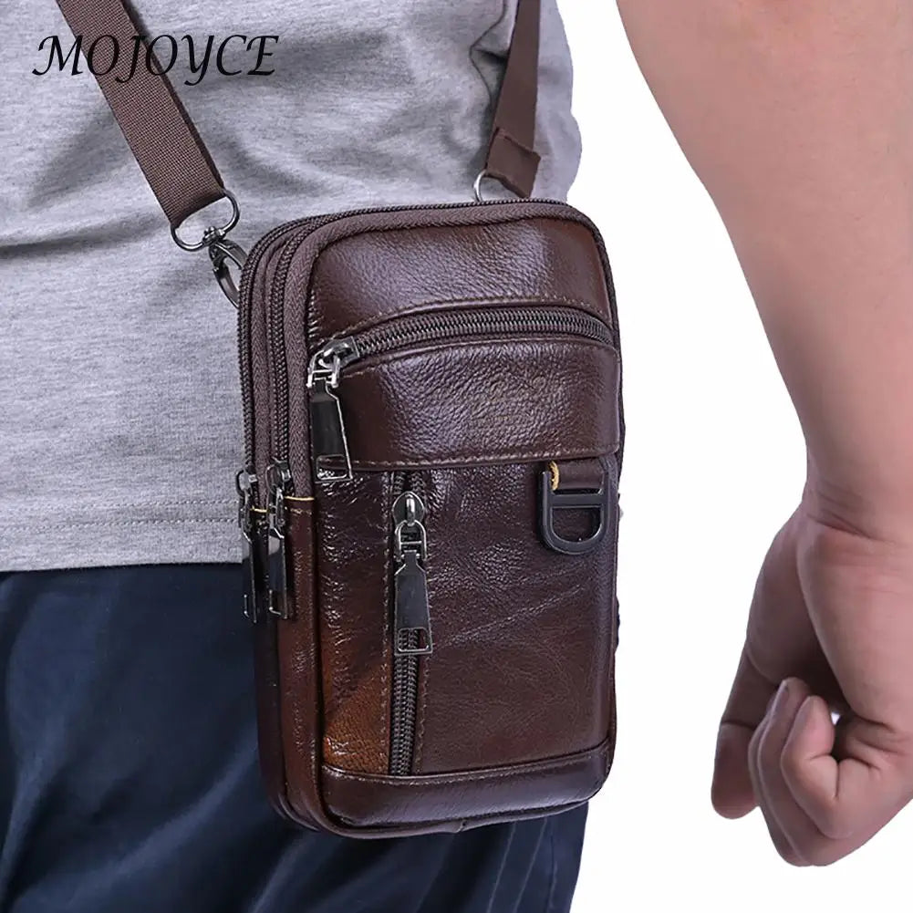 A brown vintage cowhide leather crossbody bag is shown being worn by a person.