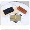 A display of genuine cow leather bifold wallets in black, brown, and beige tones on a light wooden surface.